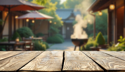 Empty rustic wooden table with copy space in sunny summer garden with small garden house...