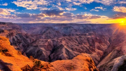 A vibrant Arizona desert landscape at sunrise and sunset offers grand views of mountains, canyons, and red rock formations under a panoramic sky with colorful clouds