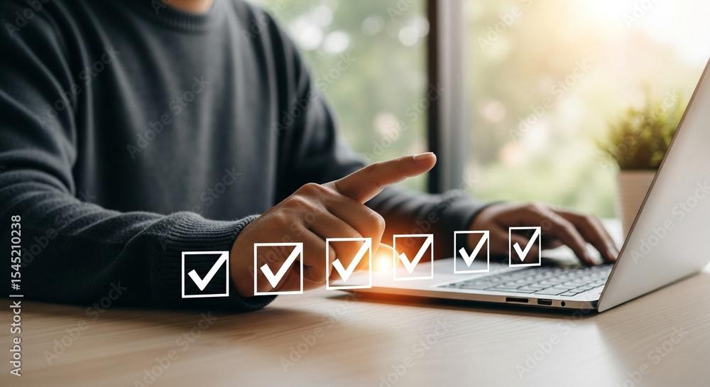 Fototapete man completing tasks on laptop with checkmarks indicating completion in a bright office setting