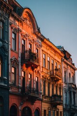 Fototapeta premium Colorful Historic Buildings Under a Clear Sky During Sunset in a European City.