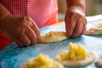 a woman makes a lot of pies out of dough. High quality photo