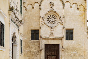 Matera, Italy. Detail of the ornate rose window and sculptural elements on the facade of San Domenico Church in Piazza Vittorio Veneto, Sassi di Matera, Italy. 