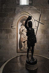 Matera, Italy. Statue of St. John the Baptist on a baptismal font in the Church of San Giovanni Battista, Matera. An older statue of the saint is visible in the background niche.
