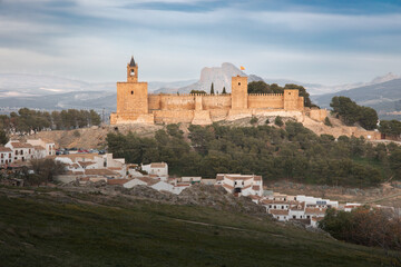 Fototapeta premium Ancient stone fortress Alcazaba on hill top in white Spanish town, Antequera, Andalusia, Spain