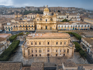 Cattedrale di San Nicolo ancient catholic cathedral and Palazzo Ducezio on cloudy day, Noto, Italy