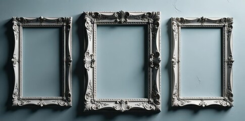 Several ornate silver frames against a subtly textured grey backdrop , still life, design