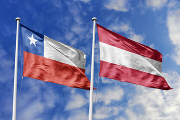 Flags of Chile and Latvia Waving Together Against a Blue Sky, Symbolizing Diplomatic Relations and International Friendship