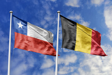 Flags of Chile and Belgium Waving Together Against a Blue Sky, Symbolizing Diplomatic Relations and International Friendship