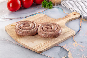 Raw meat pork and beef swirl sausages