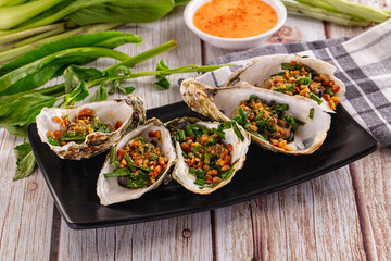 Gournet grilled oysters with onion and peanut