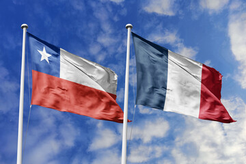 Flags of Chile and France Waving Gracefully Together Against a Blue Sky, Symbolizing Strong Diplomatic Ties and Cultural Exchange