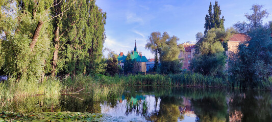 Jakabov palác (Jakab's palace) in Kosice. Lake in city park. Trees and reeds. View of the historic building in the center. Slovakia. Europe
