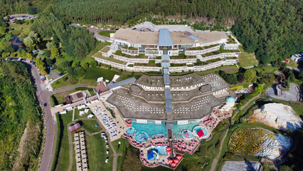View of Saliris Resort Spa Hotel. Salt hill and trees. People in the pool. Hungary Egerszalok. Europe