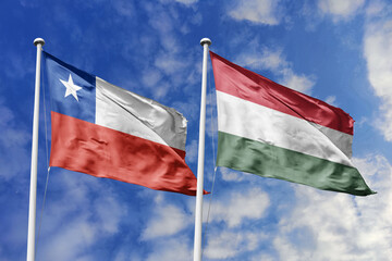 Flags of Chile and Hungary Waving Together Under a Clear Blue Sky, Symbolizing Diplomatic Ties and...