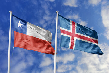 Flags of Chile and Iceland waving together against a dynamic blue sky, representing diplomatic ties, cultural exchange, and international cooperation between these distinct nations.