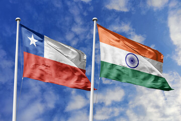 Flags of Chile and India gracefully waving under a bright blue sky, symbolizing the strong diplomatic ties, cultural exchange, and growing cooperation between these two diverse nations.
