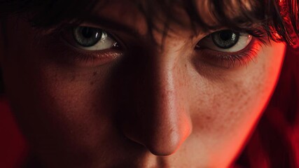 Intense close-up of a young woman with striking features and captivating gaze illuminated by warm lighting - Powered by Adobe