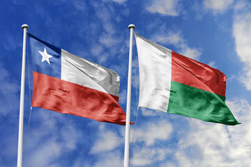 Flags of Chile and Madagascar Waving Under a Bright Blue Sky, Symbolizing International Relations...