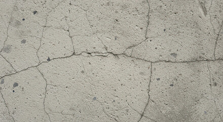 Obraz premium Close up of aged concrete surface displaying extensive network of cracks