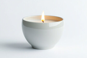 White round candle with burning wax in bowl on white background