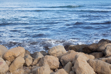 Coastal rocks and waves along the beautiful shores of Spain during a calm day in late afternoon