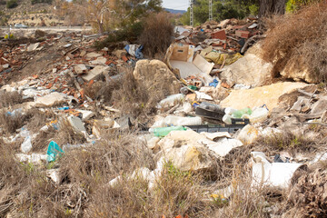 Debris and waste accumulation in an abandoned area of spain’s coastal region during daylight