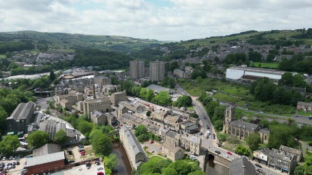 Sowerby Bridge, West Yorkshire featuring the Rochdale Canal with buildings and green hills