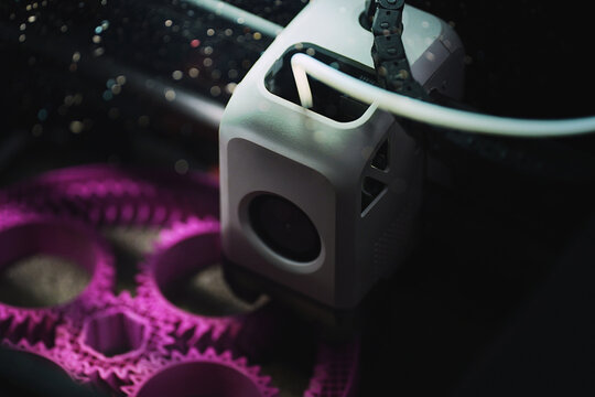 3D printing of a planetary gear model &ndash; overhead macro view of FDM printer extruding plastic filament for mechanical engineering rapid prototyping and additive manufacturing.