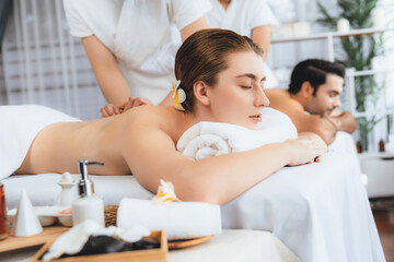 Caucasian couple customer enjoying relaxing anti-stress spa massage and pampering with beauty skin...
