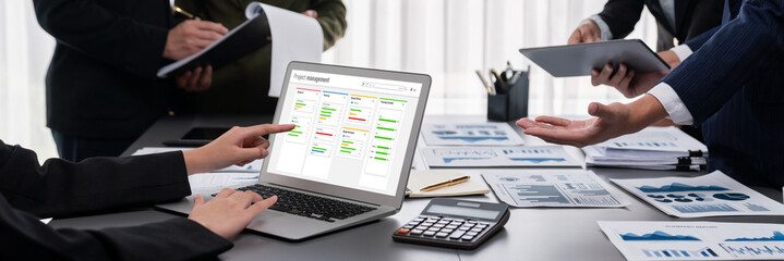 Panorama shot analyst team utilizing BI Fintech to analyze financial report with laptop....