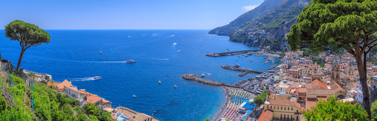  Amalfi townscape in Campania region, Italy: view of sandy beach with tourist port and historic center with iconic bell tower of cathedral.