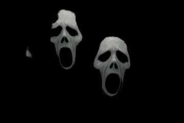 open-mouthed skulls in the dark.