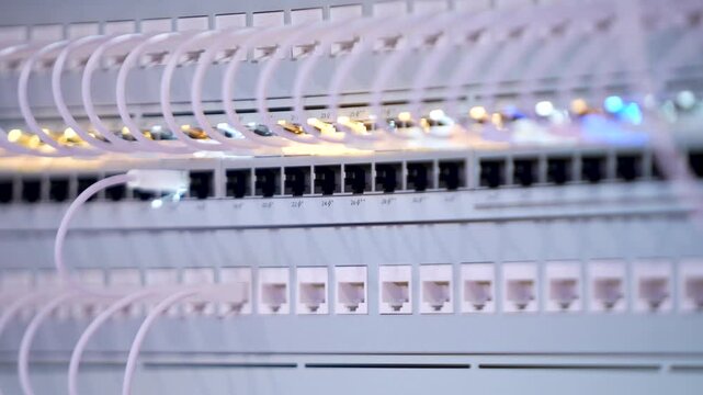Switching hubs in IPS server room with cables and glowing lights