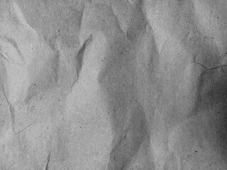 Rough and wrinkled cardboard texture in close-up, with visible creases and subtle speckles,...