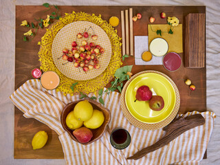 Top view flat lay of a summer-inspired moodboard and color palette arranged on a rustic wooden...