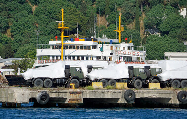 new military vehicles loaded in a harbor
