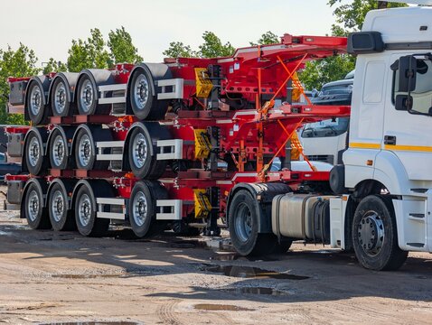 A truck with a trailer loaded with trailers