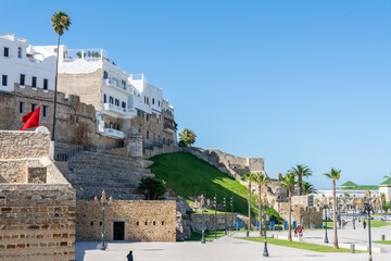 Scenic views of Tangier's seafront and old medina walls on a sunny day, showing a mix of coastal charm, public spaces, and historic Moroccan architecture