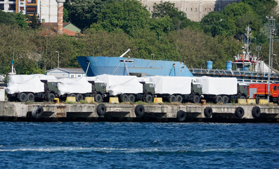 new military vehicles loaded in a harbor