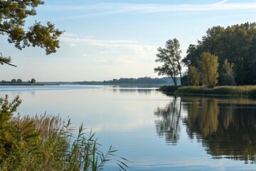 Obraz premium Nature's Mirror: A Still Lake at Sunset/Sunrise (specify if preferred)