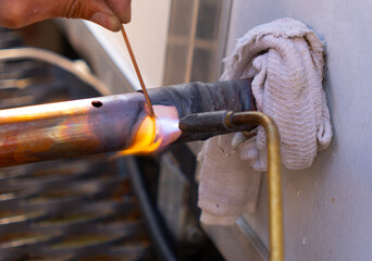 worker soldering copper pipes