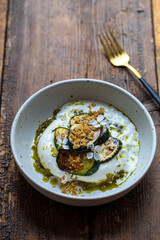 Burrata with pesto, grilled courgettes, crispy garlic breadcrumbs and radish flowers
