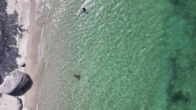 aerial view of clear water beaches and rocks captures a beautiful coastal scene perfect for broll showcasing natural seaside landscapes from above 