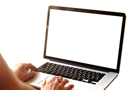 Rear view of high school girl using laptop for doing homework, browsing Internet, searching for required information, sitting at desk with mobile phone with copy space screen lying next to her