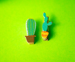 Creative Cactus Clip Decor on Vibrant Green Background
Cactus Figurines Attached to Wooden...