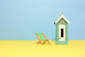 isolated deckchair and wooden beach hut.