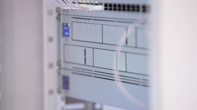 Switching hubs in IPS server room with cables and glowing lights