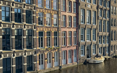A boat sits alongside an Amsterdam facade