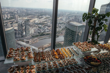 Exquisite buffet setup featuring platters of fresh fruits, savory canapés, and delectable...