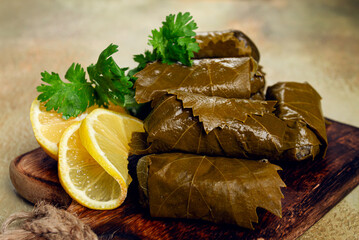 dolma, minced meat with rice, in grape leaves, minced meat rolls, on a chopping board, top view, no...